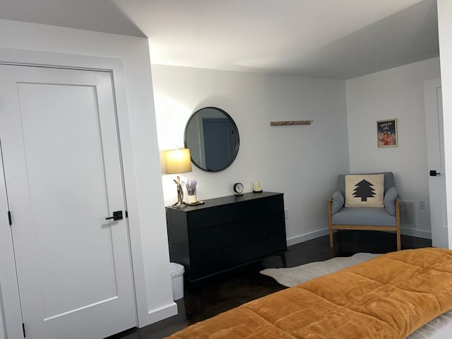 bedroom featuring a closet and dark wood-type flooring