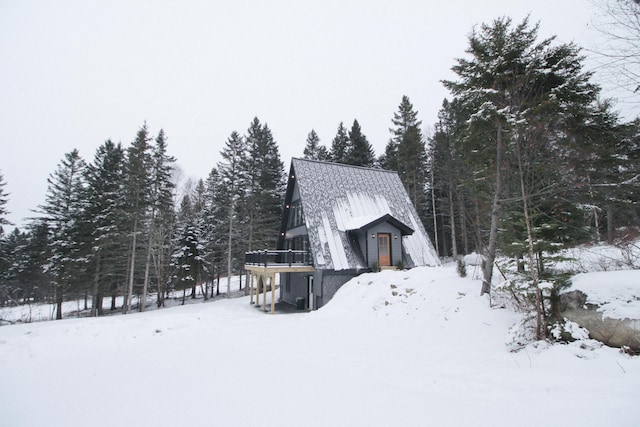 view of snow covered exterior with a deck