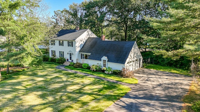 view of front of home with a front yard and a garage