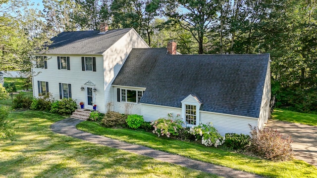 colonial inspired home with a front lawn