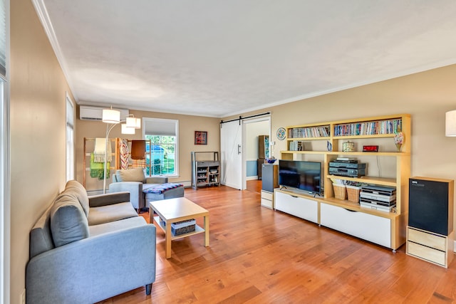 living room featuring a barn door, ornamental molding, hardwood / wood-style flooring, and a wall mounted AC