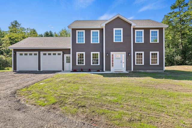 colonial house with a front lawn and a garage