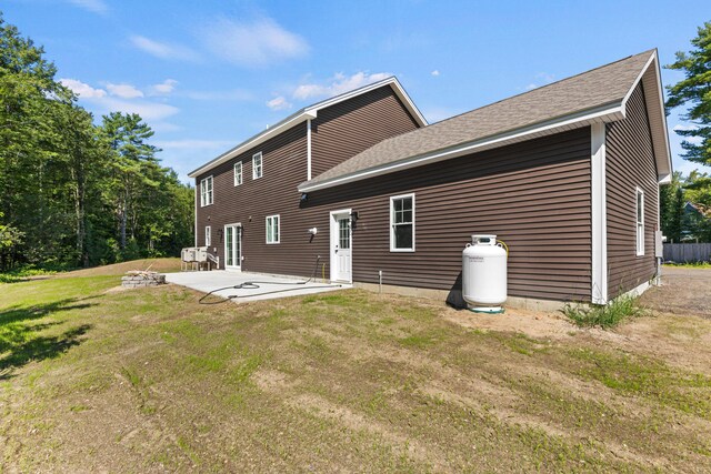 rear view of house with a lawn and a patio area