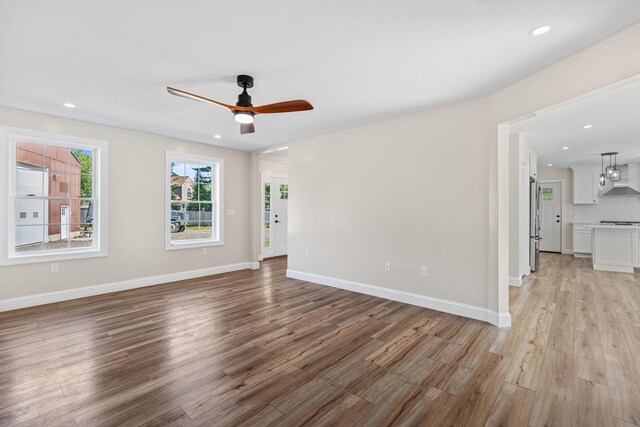 unfurnished room featuring ceiling fan and light hardwood / wood-style flooring