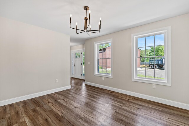 interior space with dark hardwood / wood-style floors and a notable chandelier