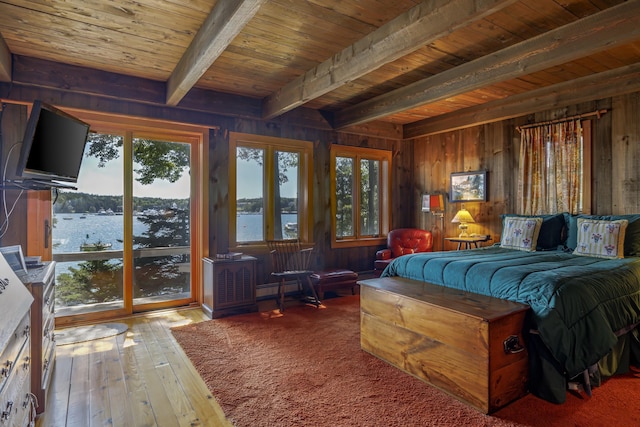 bedroom featuring access to exterior, beam ceiling, wooden walls, wooden ceiling, and hardwood / wood-style flooring