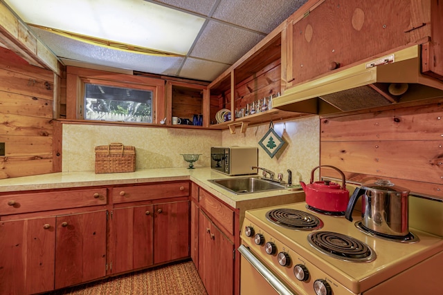 kitchen featuring under cabinet range hood, electric range, a sink, light countertops, and open shelves