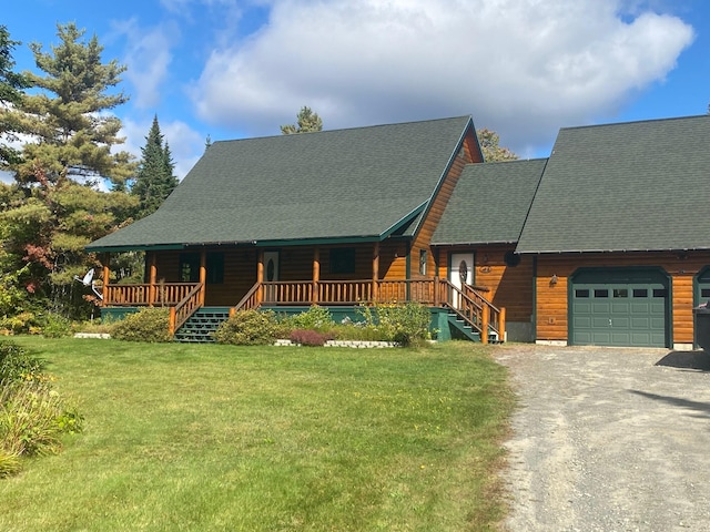 log home featuring a porch, a garage, and a front yard