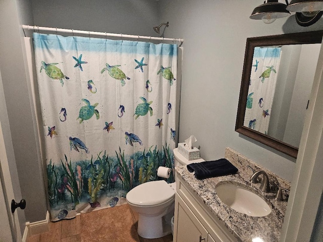 bathroom with tile patterned floors, vanity, walk in shower, and toilet