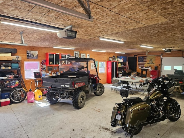 garage with a workshop area and a garage door opener