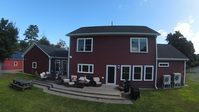 rear view of property featuring a yard and a wooden deck