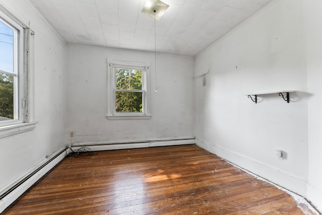 empty room featuring crown molding, dark hardwood / wood-style flooring, and a baseboard radiator