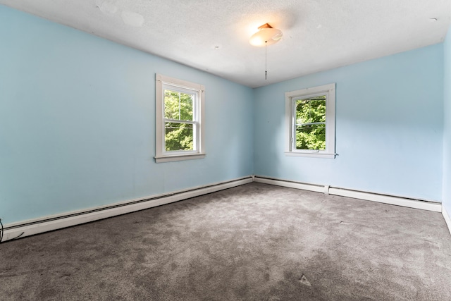 spare room featuring a baseboard radiator, a textured ceiling, and carpet flooring