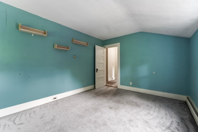 unfurnished bedroom featuring carpet, lofted ceiling, and baseboard heating