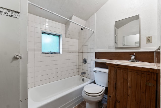 full bathroom featuring vanity, toilet, and tiled shower / bath