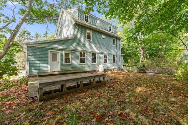 rear view of property featuring a deck