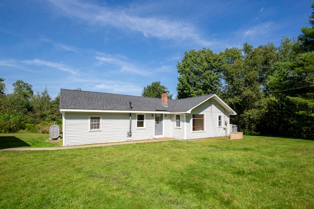 rear view of house with a lawn