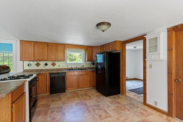 kitchen with black appliances, a textured ceiling, sink, and tasteful backsplash