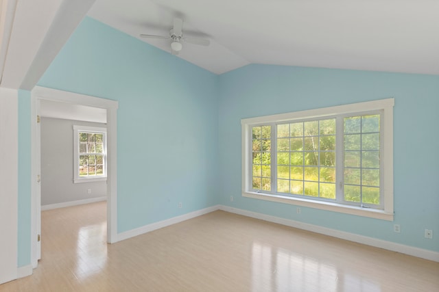 spare room featuring ceiling fan, light wood-type flooring, and vaulted ceiling