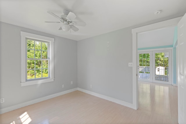 unfurnished room with french doors, ceiling fan, and light hardwood / wood-style flooring