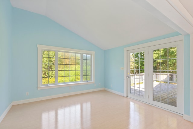 unfurnished room with light hardwood / wood-style flooring and vaulted ceiling