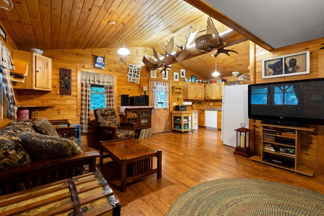 living room with wooden walls, vaulted ceiling, and light hardwood / wood-style floors