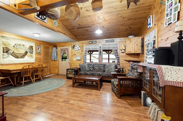 living room featuring wooden walls, lofted ceiling, and light wood-type flooring