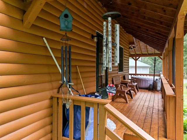 wooden terrace with a hot tub