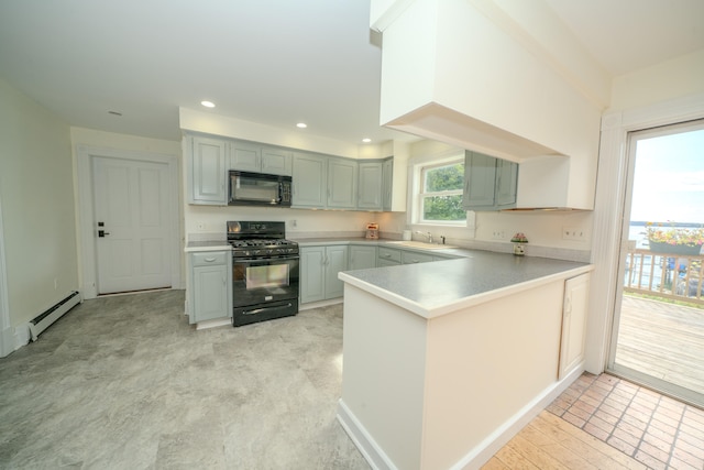 kitchen with a baseboard heating unit, sink, kitchen peninsula, and range with gas cooktop