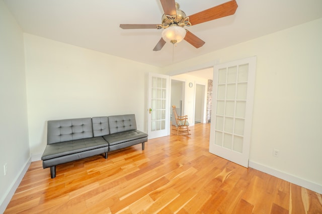 sitting room with ceiling fan, french doors, and light hardwood / wood-style floors