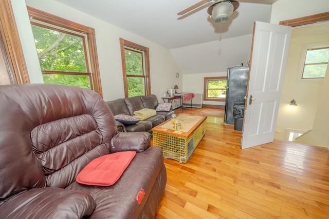 living room with light wood-type flooring, vaulted ceiling, and ceiling fan