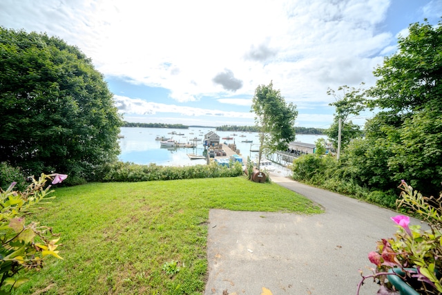 view of yard with a dock and a water view