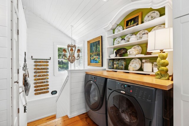 washroom with washer and clothes dryer and light hardwood / wood-style floors