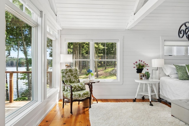 sunroom / solarium with plenty of natural light and lofted ceiling with beams