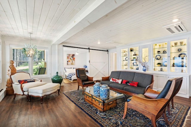 living room with a barn door, an inviting chandelier, dark hardwood / wood-style flooring, and wooden ceiling