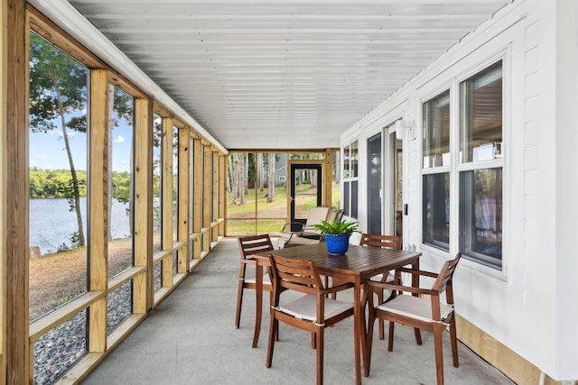 sunroom / solarium featuring a healthy amount of sunlight and a water view