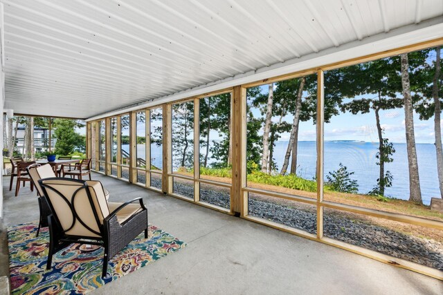 sunroom / solarium featuring a water view