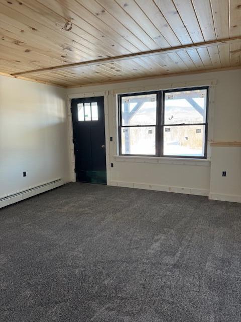 entryway with a baseboard heating unit, a healthy amount of sunlight, wood ceiling, and dark carpet