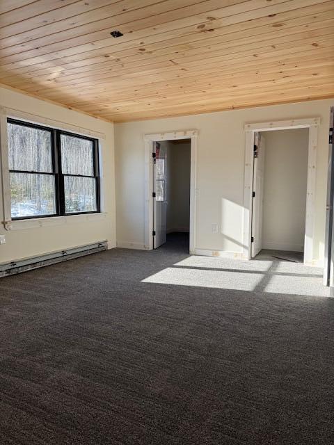 carpeted spare room with baseboard heating and wooden ceiling