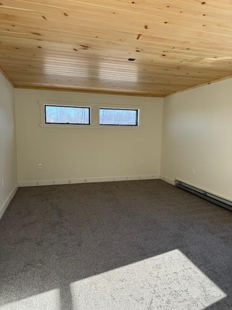 unfurnished room with wooden ceiling, a healthy amount of sunlight, and baseboard heating