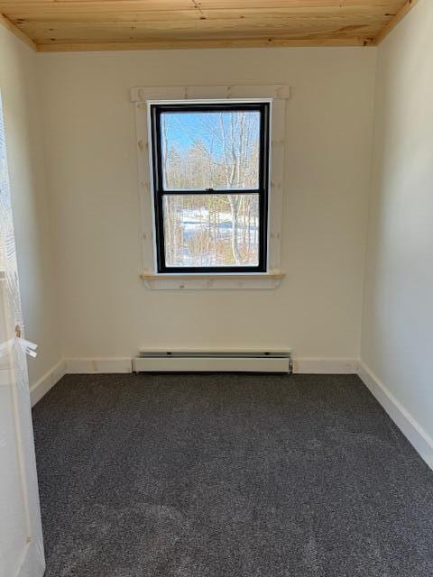 carpeted empty room featuring a baseboard radiator and wood ceiling