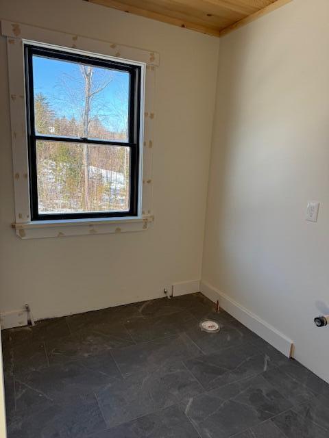 unfurnished room with wood ceiling