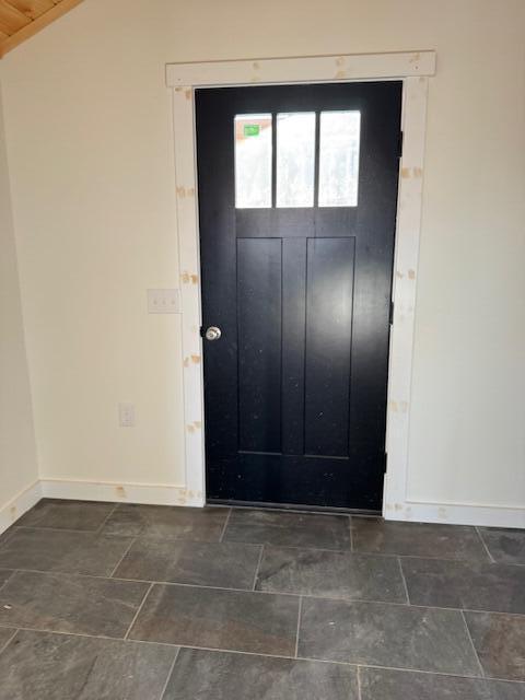 foyer featuring vaulted ceiling