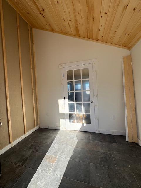 unfurnished room featuring lofted ceiling and wooden ceiling