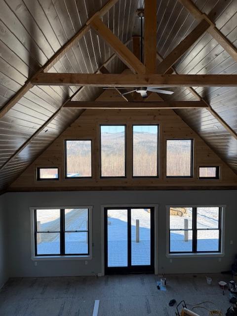 interior space featuring wood ceiling, plenty of natural light, and beam ceiling