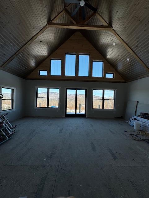 unfurnished living room with high vaulted ceiling