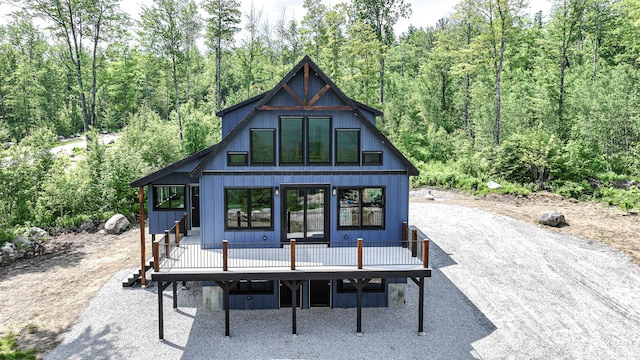 48 Harmony Row, Bethel, ME 04217 - view of front facade with a wooden deck and a wooded view