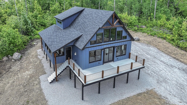 48 Harmony Row, Bethel, ME 04217 - view of front of home with a shingled roof, a view of trees, and stairs