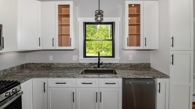 48 Harmony Row, Bethel, ME 04217 - kitchen featuring white cabinets, glass insert cabinets, stainless steel appliances, and pendant lighting