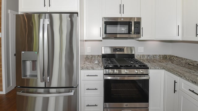 48 Harmony Row, Bethel, ME 04217 - kitchen featuring stainless steel appliances, white cabinetry, light stone counters, and dark wood-style flooring